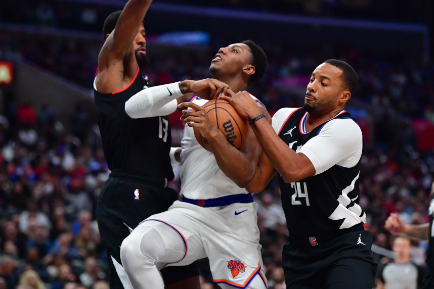 Los Angeles Clippers forward Paul George (13) and guard Norman Powell (24) defend against New York Knicks guard RJ Barrett (9) during the second half at Crypto.com Arena