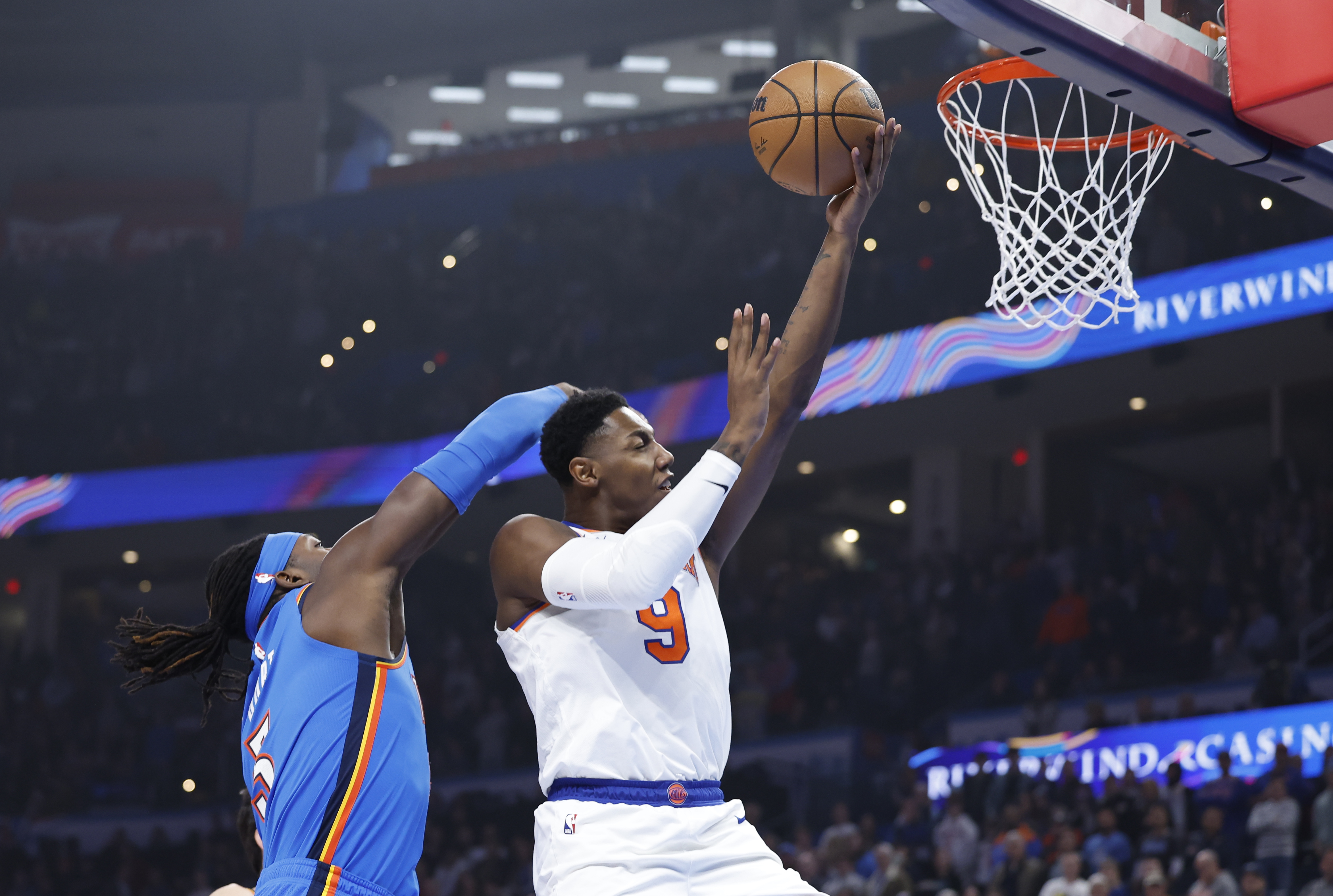 New York Knicks guard RJ Barrett (9) is fouled by Oklahoma City Thunder guard Shai Gilgeous-Alexander (2) on the way to the basket during the first quarter at Paycom Center