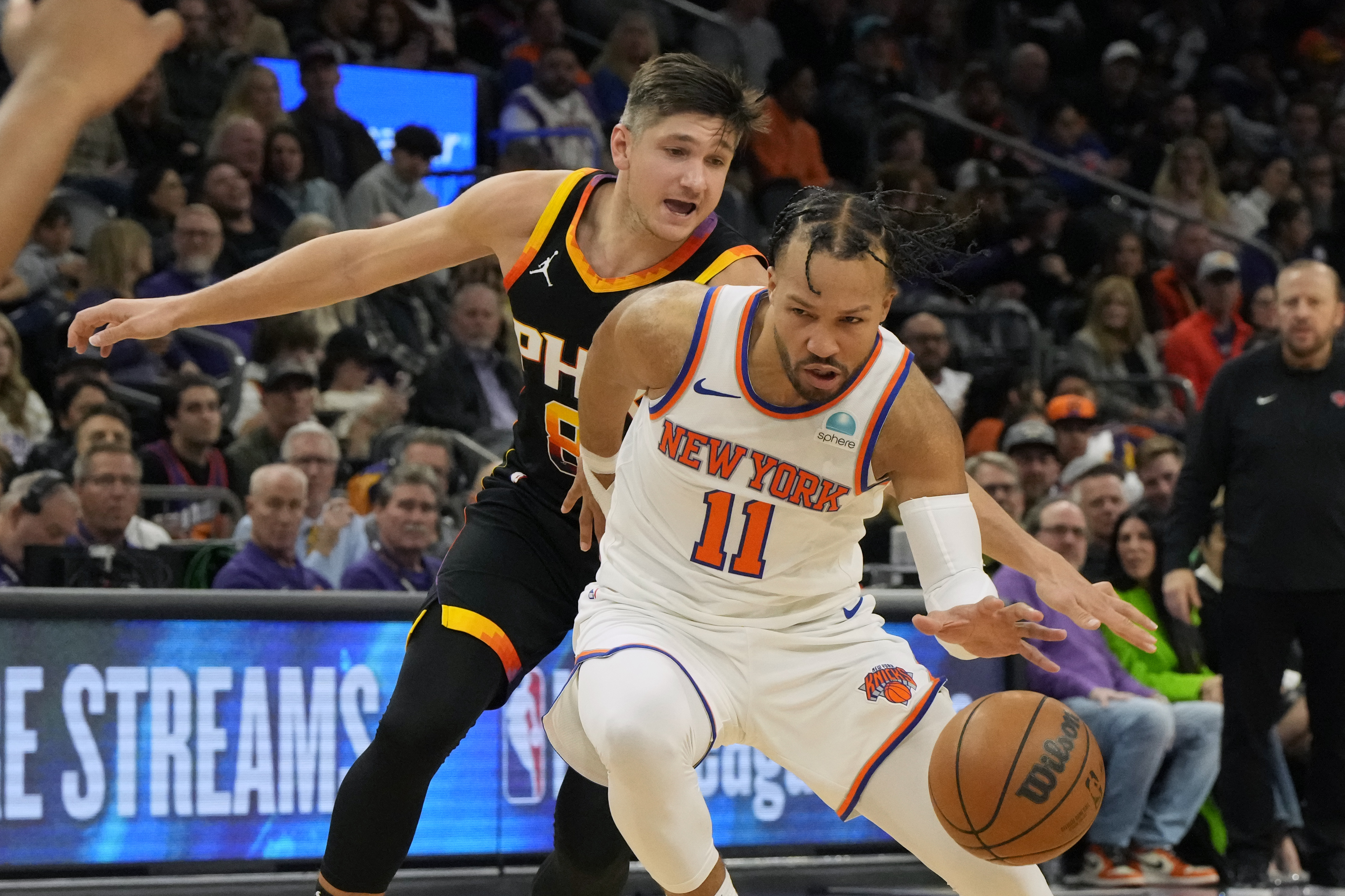 New York Knicks guard Jalen Brunson (11) drives on Phoenix Suns guard Grayson Allen (8) in the second half at Footprint Center