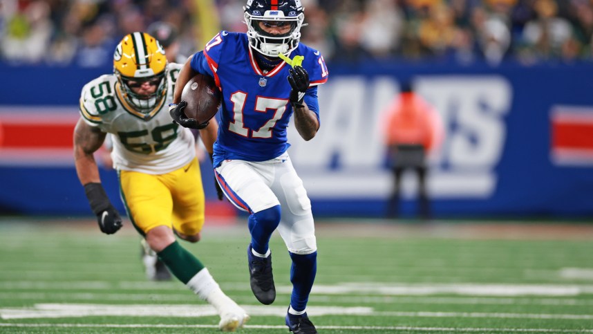 New York Giants wide receiver Wan'Dale Robinson (17) scrambles with the ball as Green Bay Packers linebacker Isaiah McDuffie (58) defends during the second quarter at MetLife Stadium