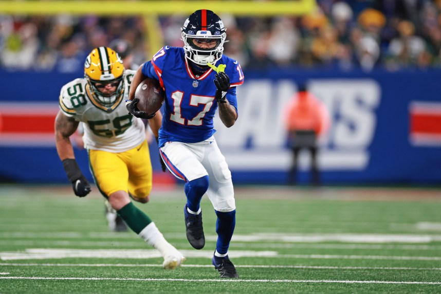 New York Giants wide receiver Wan'Dale Robinson (17) scrambles with the ball as Green Bay Packers linebacker Isaiah McDuffie (58) defends during the second quarter at MetLife Stadium