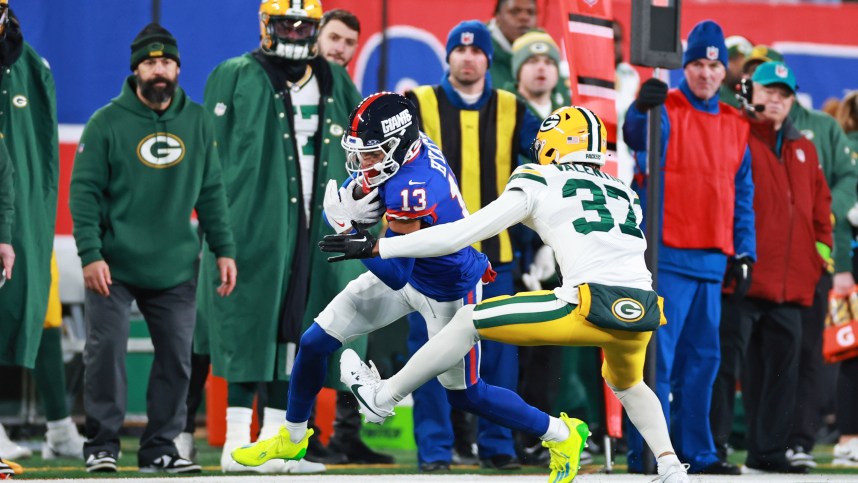 New York Giants wide receiver Jalin Hyatt (13) runs the ball as Green Bay Packers cornerback Carrington Valentine (37) defends during the second quarter at MetLife Stadium