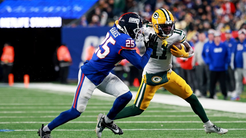 Green Bay Packers wide receiver Jayden Reed (11) runs the ball after a catch against New York Giants cornerback Deonte Banks (25) during the fourth quarter at MetLife Stadium