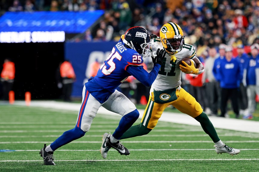 Green Bay Packers wide receiver Jayden Reed (11) runs the ball after a catch against New York Giants cornerback Deonte Banks (25) during the fourth quarter at MetLife Stadium