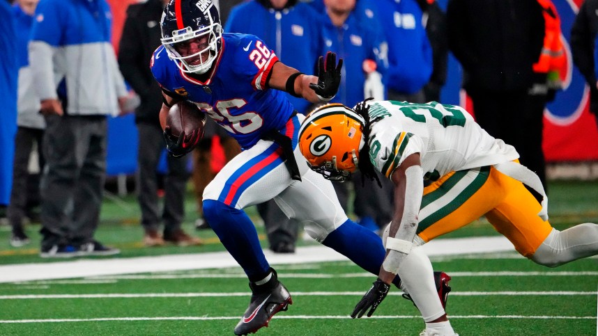 New York Giants running back Saquon Barkley (26) runs the ball against Green Bay Packers safety Darnell Savage (26) during the fourth quarter at MetLife Stadium