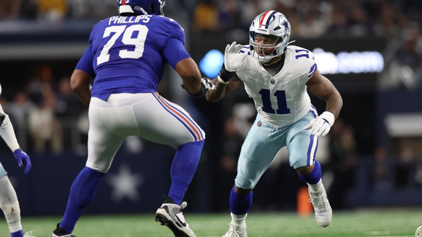 Dallas Cowboys linebacker Micah Parsons (11) rushes against New York Giants offensive tackle Tyre Phillips (79) during the game