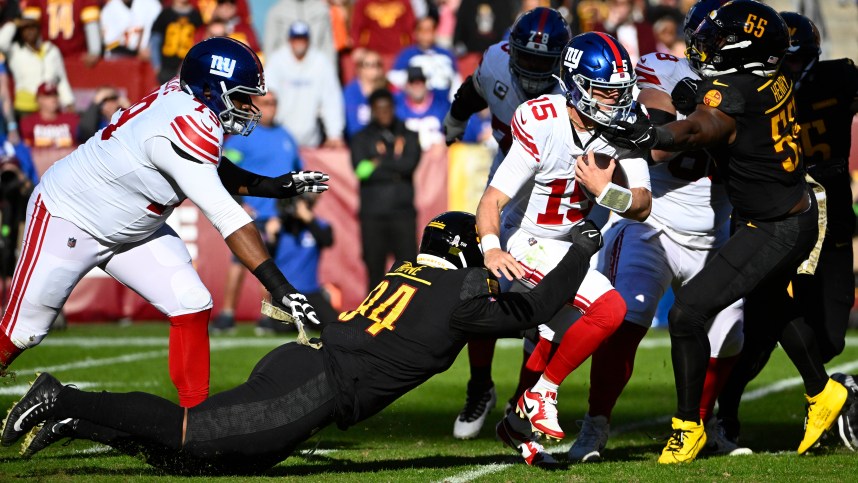 Washington Commanders defensive tackle Daron Payne (94) sacks New York Giants quarterback Tommy DeVito (15) during the first half at FedExField