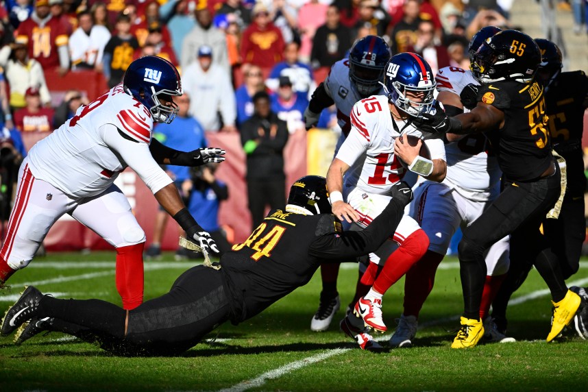 Washington Commanders defensive tackle Daron Payne (94) sacks New York Giants quarterback Tommy DeVito (15) during the first half at FedExField