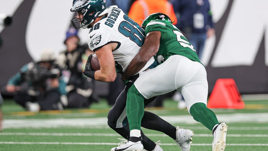 Philadelphia Eagles tight end Dallas Goedert (88) fights for yards as New York Jets linebacker Quincy Williams (56) tackles during the second half at MetLife Stadium.