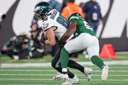 Philadelphia Eagles tight end Dallas Goedert (88) fights for yards as New York Jets linebacker Quincy Williams (56) tackles during the second half at MetLife Stadium.