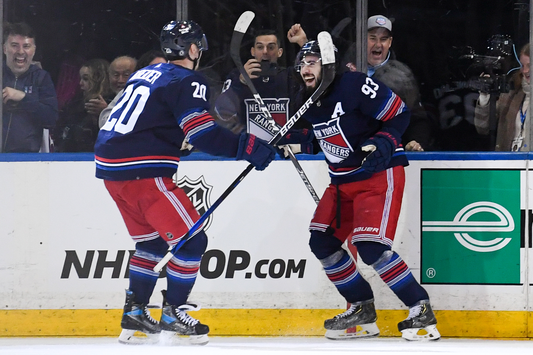 New York Rangers left wing Chris Kreider (20) celebrates his overtime winning goal against the Buffalo Sabres with New York Rangers center Mika Zibanejad (93) during the overtime period at Madison Square Garden