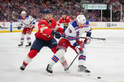 Florida Panthers defenseman Gustav Forsling (42) battles New York Rangers left wing Artemi Panarin (10) for the puck during the first period at Amerant Bank Arena