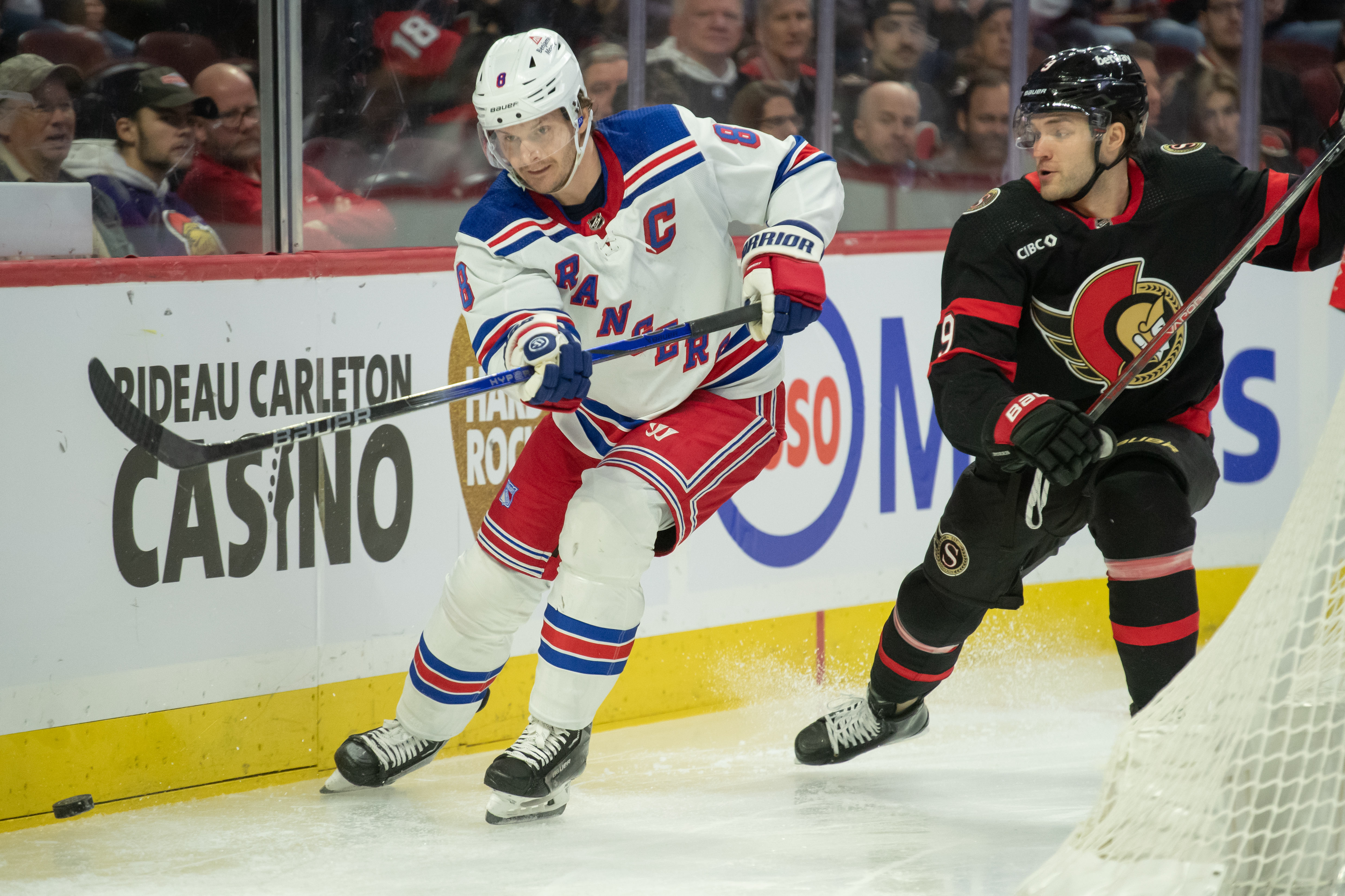 New York Rangers defenseman Jacob Trouba (8) moves the puck away from Ottawa Senators center Josh Norris (9) in the first period at the Canadian