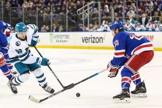 San Jose Sharks right wing Kevin Labanc (62) attempts to shoot the puck past New York Rangers defenseman Adam Fox (23) in the first period at Madison Square Garden