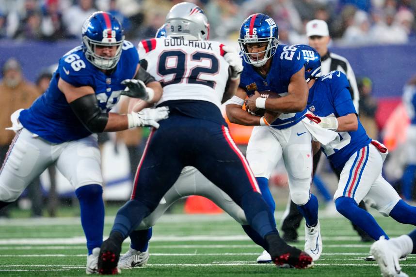 New York Giants running back Saquon Barkley (26) runs with the ball during the second half, Sunday, November 26, 2023.