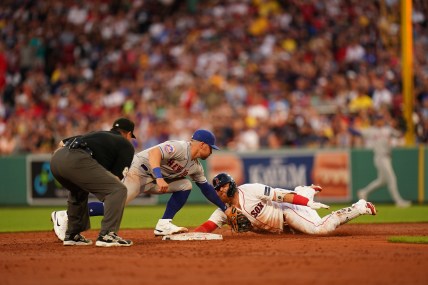 Boston Red Sox designated hitter Justin Turner (2) safe at second with a double against New York Mets second baseman Danny Mendick (15) in the third inning at Fenway Park
