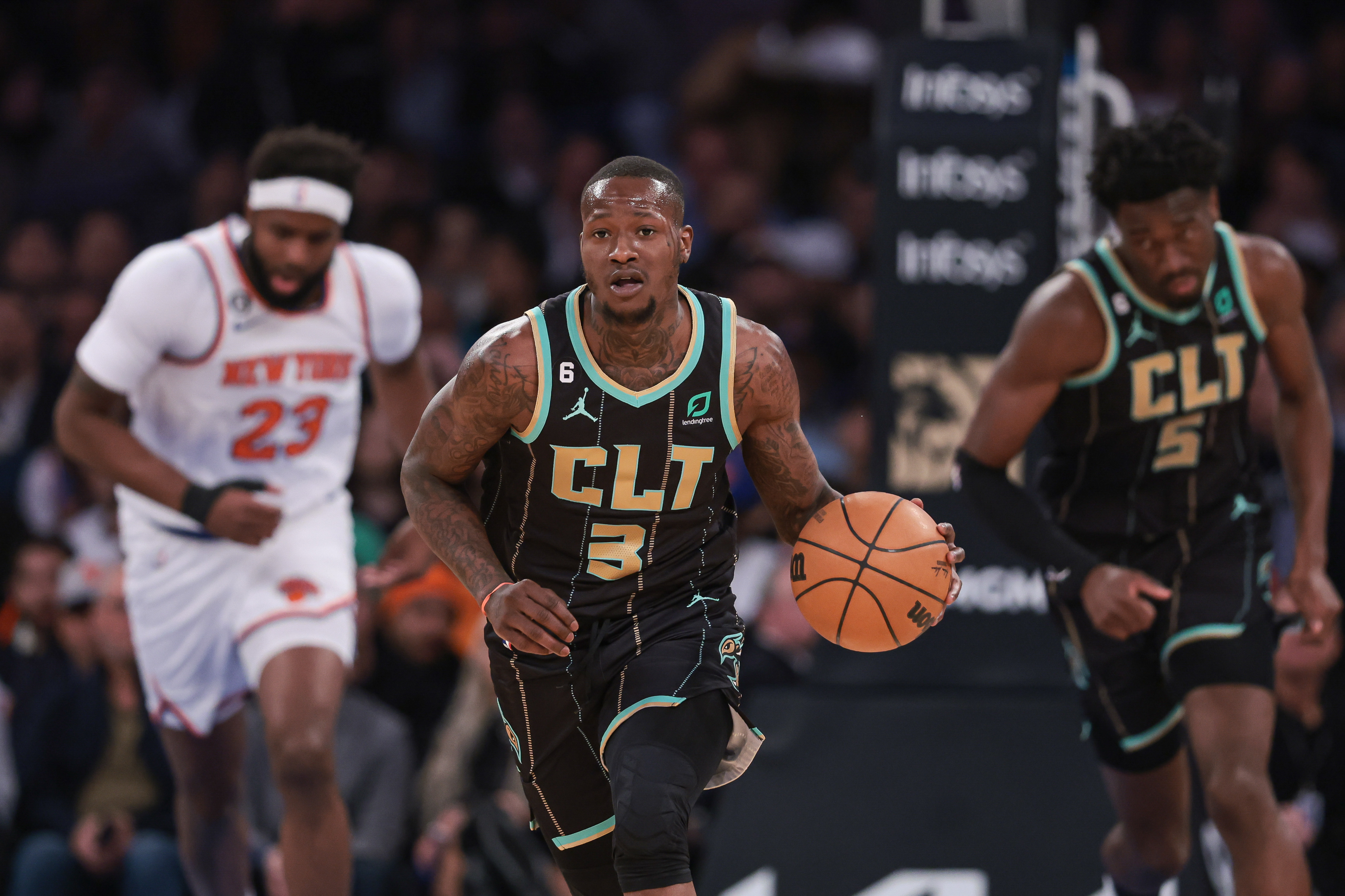 Charlotte Hornets guard Terry Rozier (3) dribbles up court  in front of New York Knicks center Mitchell Robinson (23) and center Mark Williams (5) during the first quarter at Madison Square Garden