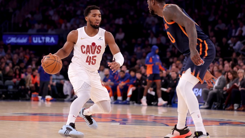 Cleveland Cavaliers guard Donovan Mitchell (45) controls the ball against New York Knicks forward Julius Randle (30) during the first quarter at Madison Square Garden