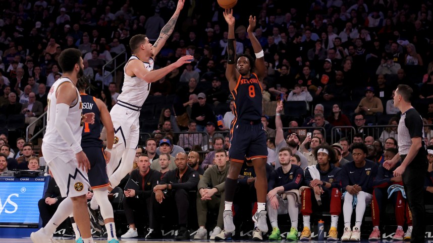 New York Knicks forward OG Anunoby (8) shoots a three point shot against Denver Nuggets forward Michael Porter Jr. (1) and Denver Nuggets guard Jamal Murray (27) during the third quarter at Madison Square Garden