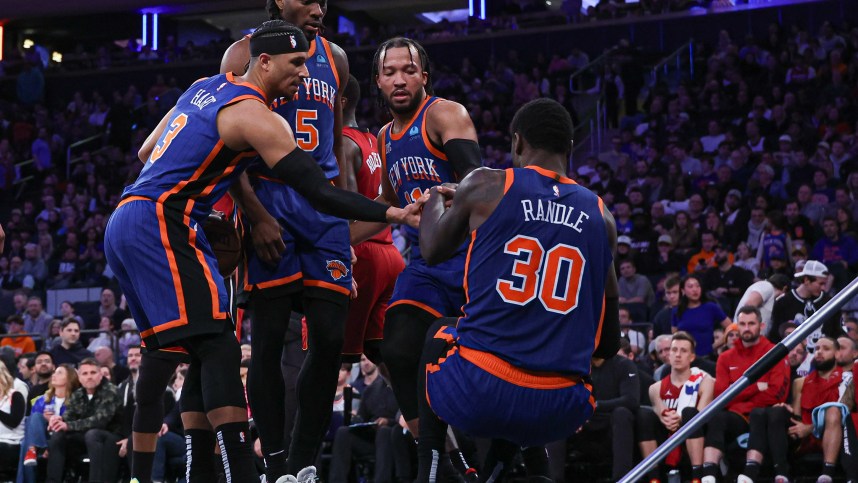 New York Knicks forward Julius Randle (30) is helped up by teammates after being injured during the second half against the Miami Heat at Madison Square Garden