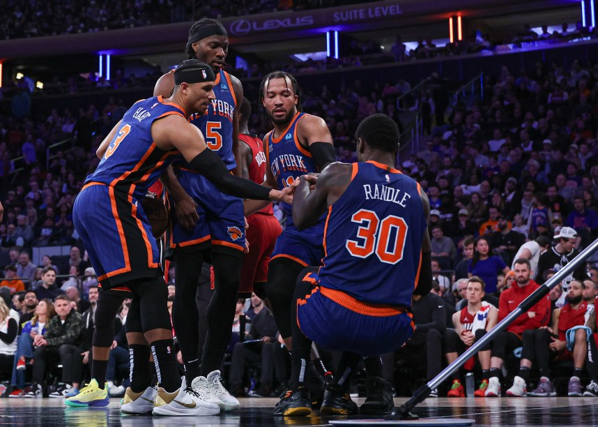 New York Knicks forward Julius Randle (30) is helped up by teammates after being injured during the second half against the Miami Heat at Madison Square Garden