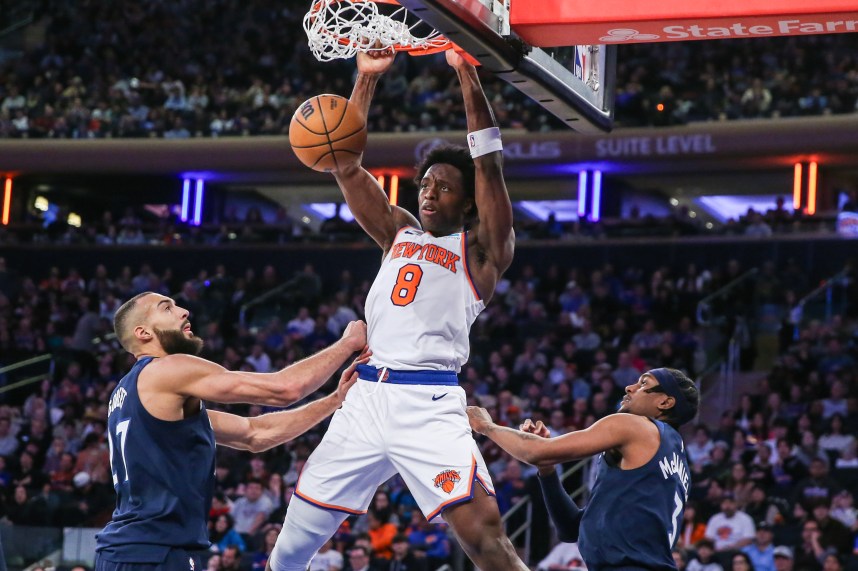 New York Knicks forward OG Anunoby (8) dunks past Minnesota Timberwolves center Rudy Gobert (27) in the third quarter at Madison Square Garden