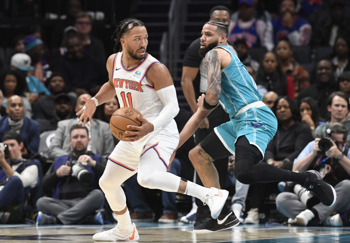 New York Knicks guard Jalen Brunson (11) moves past Charlotte Hornets forward Cody Martin (11) during the second half at the Spectrum Center