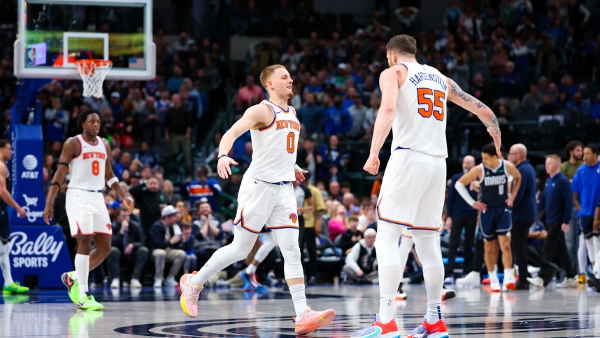 New York Knicks guard Donte DiVincenzo (0) celebrates with New York Knicks center Isaiah Hartenstein (55) after scoring during the second half against the Dallas Mavericks at American Airlines Center