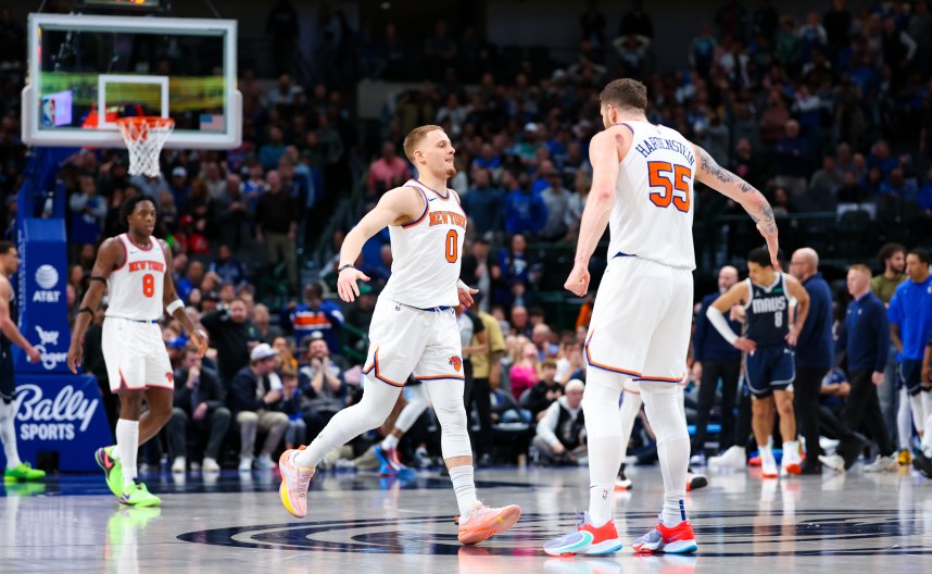 New York Knicks guard Donte DiVincenzo (0) celebrates with New York Knicks center Isaiah Hartenstein (55) after scoring during the second half against the Dallas Mavericks at American Airlines Center