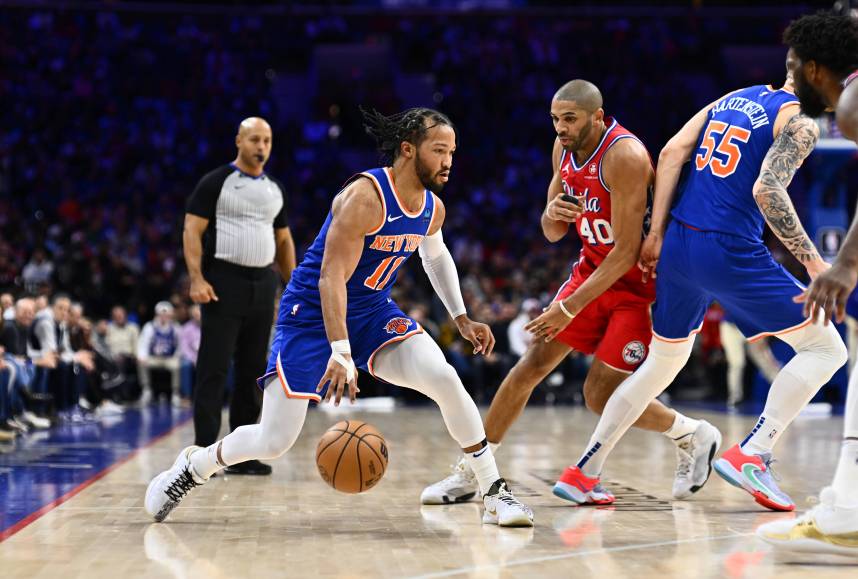 New York Knicks guard Jalen Brunson (11) controls the ball against the Philadelphia 76ers in the first quarter at Wells Fargo Center