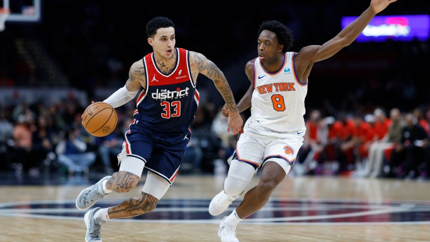 Washington Wizards forward Kyle Kuzma (33) drives to the basket as New York Knicks forward OG Anunoby (8) defends in the third quarter at Capital One Arena