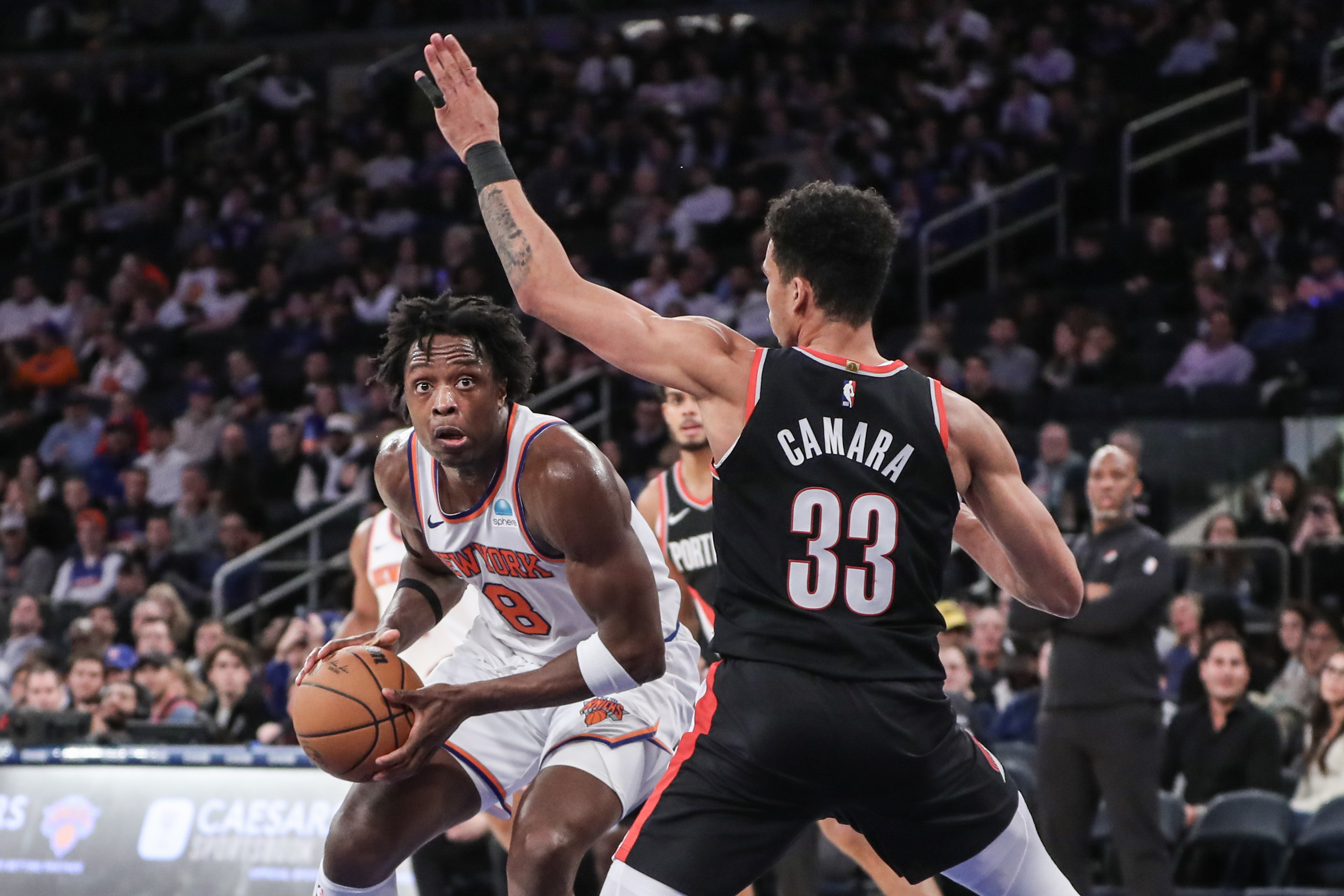 New York Knicks forward OG Anunoby (8) looks to drive past Portland Trail Blazers forward Toumani Camara (33) in the fourth quarter at Madison Square Garden