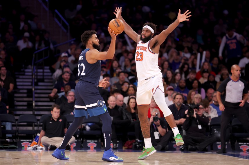 Minnesota Timberwolves center Karl-Anthony Towns (32) looks to pass the ball against New York Knicks center Mitchell Robinson (23) during the third quarter at Madison Square Garden