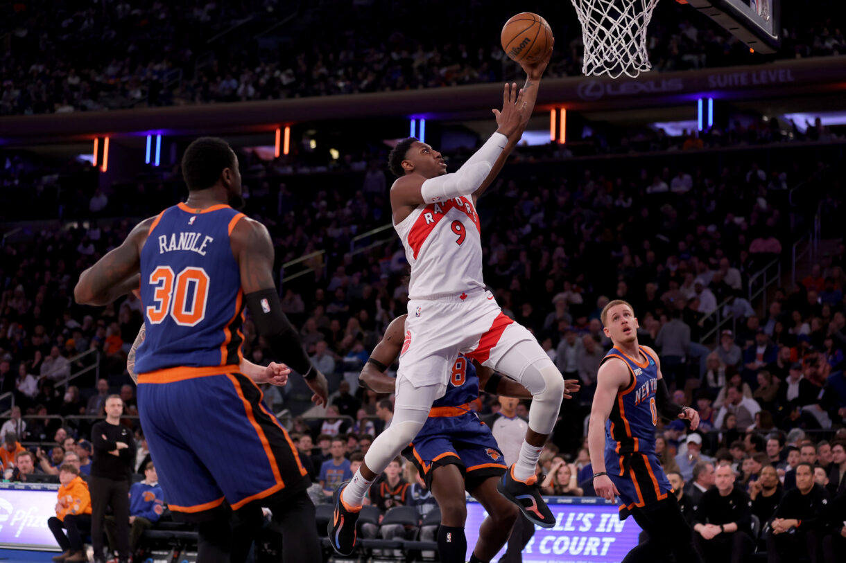 Toronto Raptors guard RJ Barrett (9) drives to the basket against New York Knicks forwards Julius Randle (30) and OG Anunoby (8) and guard Donte DiVincenzo (0) during the third quarter at Madison Square Garden