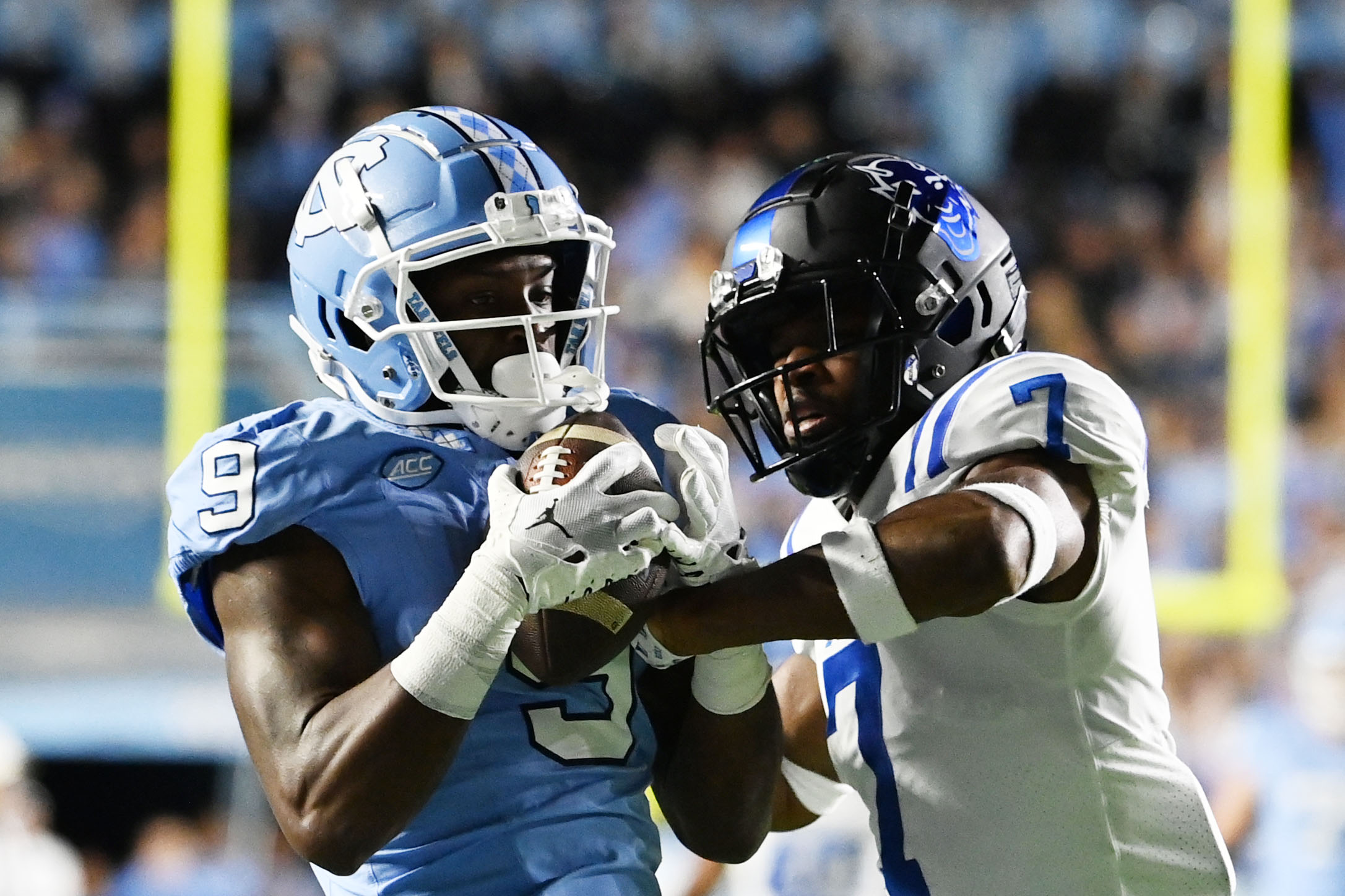 North Carolina Tar Heels wide receiver Devontez Walker (9) (New York Giants prospect) catches the ball as Duke Blue Devils cornerback Al Blades Jr. (7) defends in the first quarter at Kenan Memorial Stadium