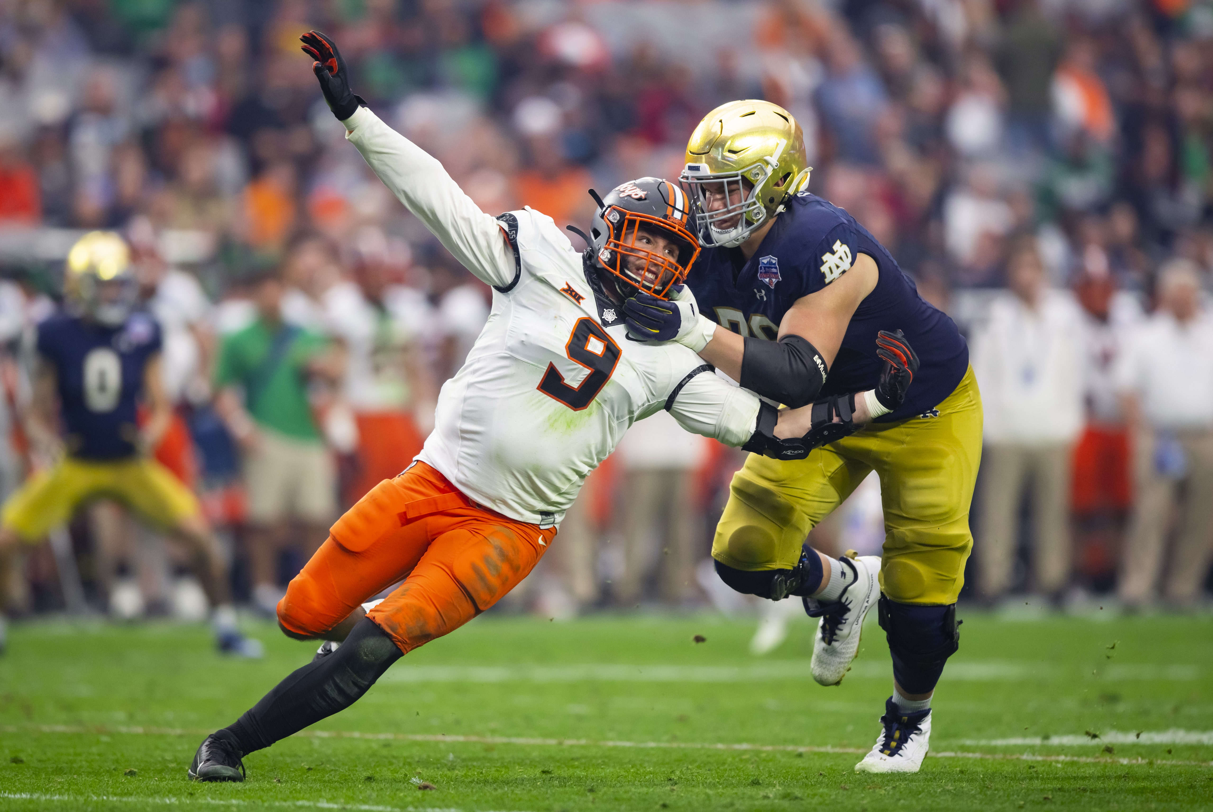 Notre Dame Fighting Irish offensive lineman Joe Alt (76) (New York Giants Prospect) defends against Oklahoma State Cowboys defensive end Brock Martin (9) in the 2022 Fiesta Bowl at State Farm Stadium
