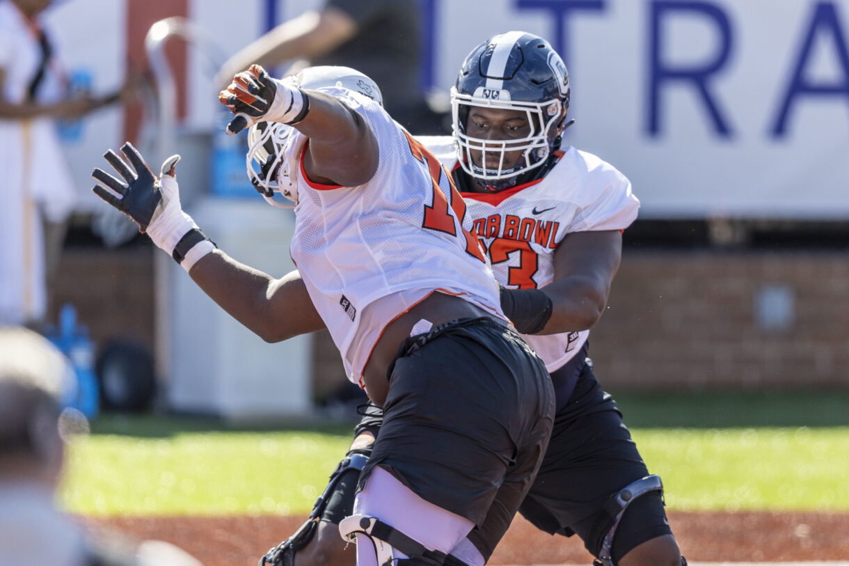 American offensive lineman Christian Haynes of Uconn (63) (New York Giants prospect) faces off against American offensive lineman Christian Jones of Texas (70) during practice for the American team at Hancock Whitney Stadium