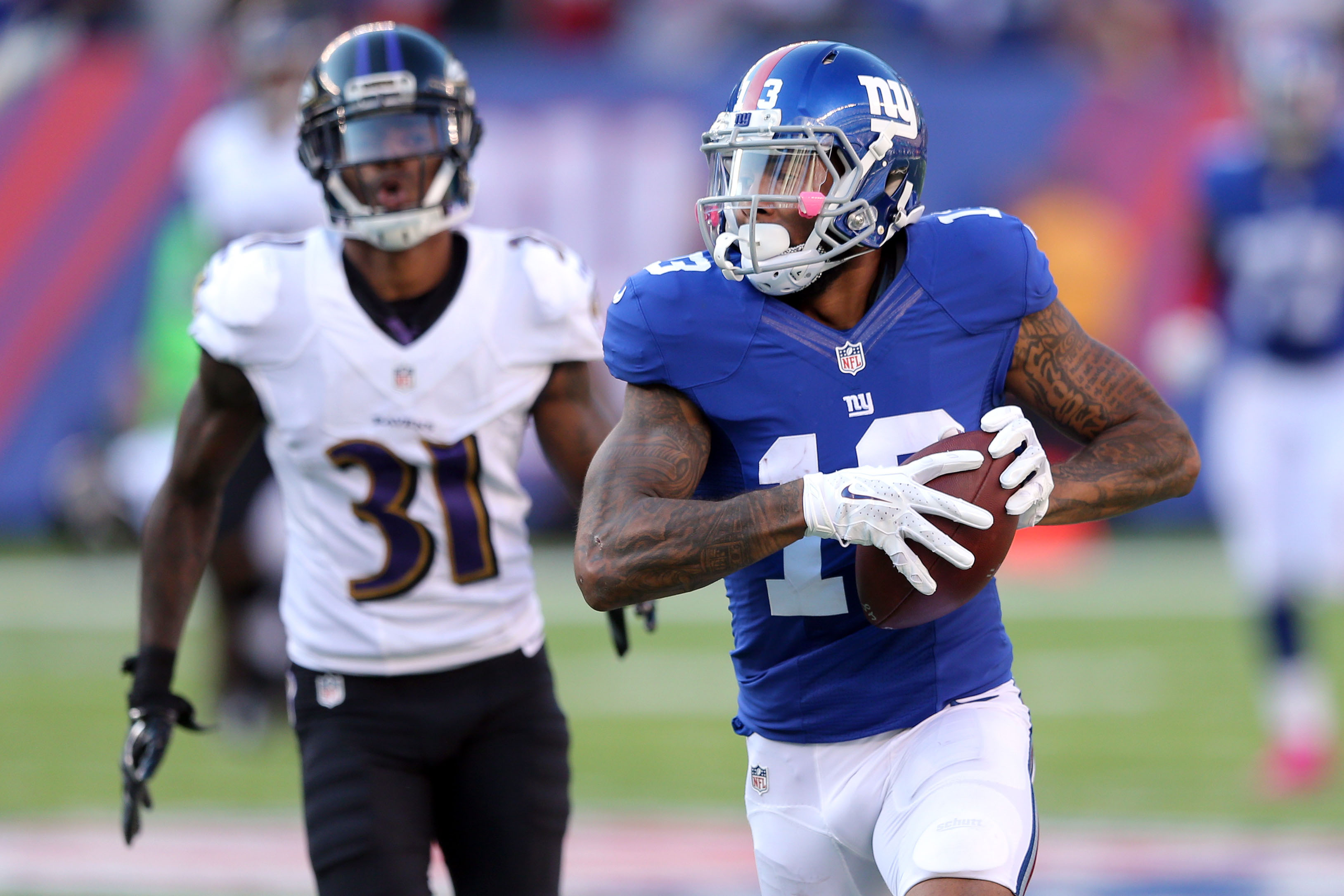 New York Giants wide receiver Odell Beckham Jr. (13) runs for a touchdown against Baltimore Ravens corner back Will Davis (31) during the fourth quarter at MetLife Stadium