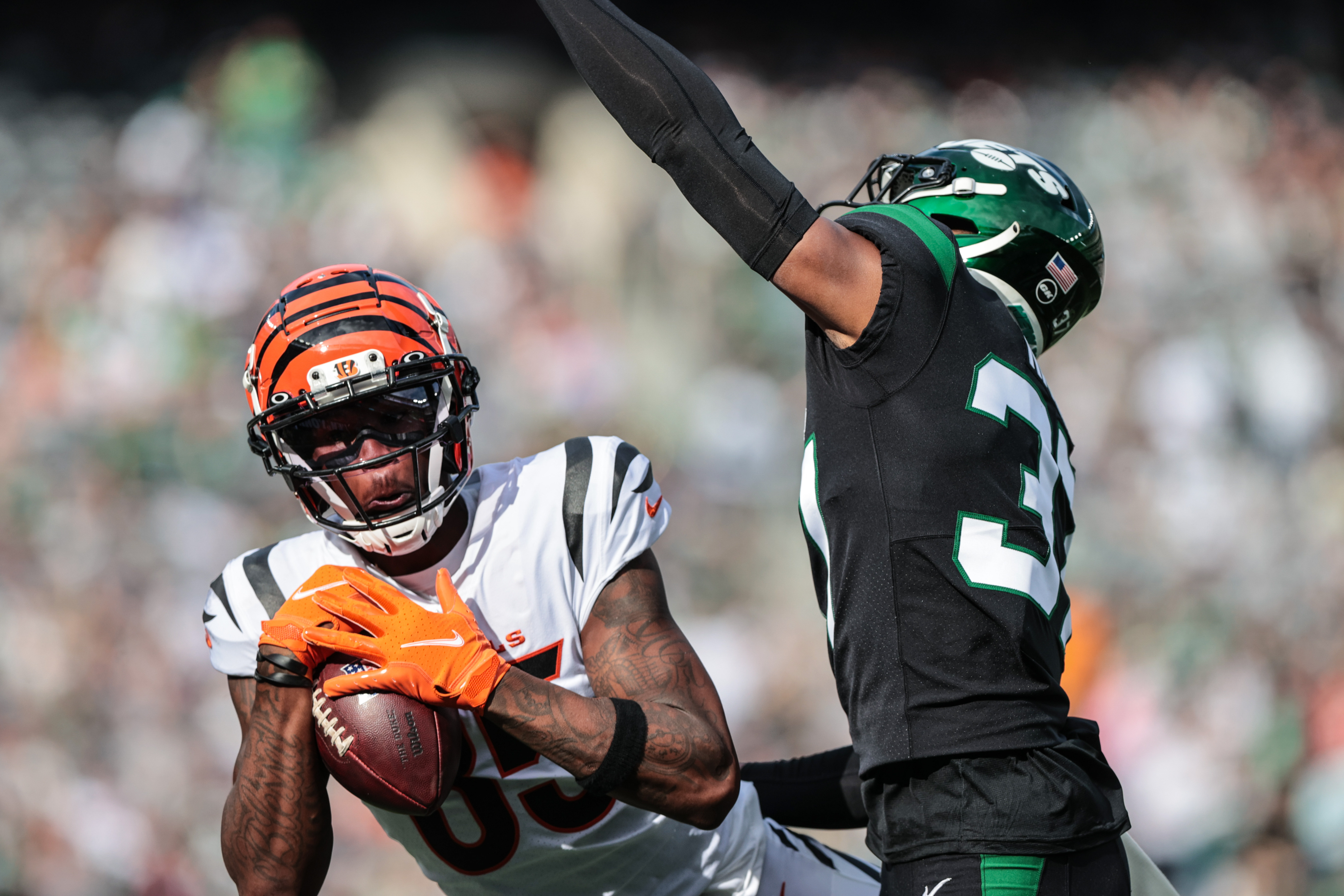 Cincinnati Bengals wide receiver Tee Higgins (85) catches the ball as New York Jets cornerback Bryce Hall (37) defends during the first half at MetLife Stadium