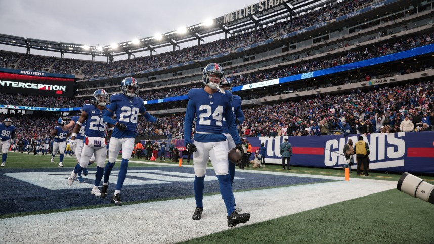 New York Giants safety Dane Belton (24) celebrates with teammates after an interception during the second half against the Los Angeles Rams at MetLife Stadium