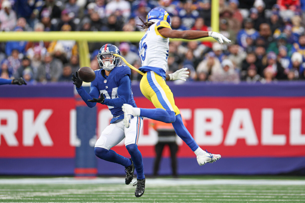 New York Giants safety Dane Belton (24) intercepts a pass intended for Los Angeles Rams wide receiver Demarcus Robinson (15) during the second half at MetLife Stadium