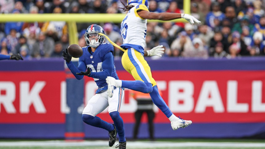 New York Giants safety Dane Belton (24) intercepts a pass intended for Los Angeles Rams wide receiver Demarcus Robinson (15) during the second half at MetLife Stadium