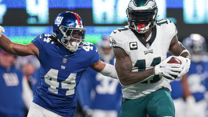Philadelphia Eagles wide receiver A.J. Brown (11) catches the ball as New York Giants cornerback Nick McCloud (44) pursues during the first quarter at MetLife Stadium