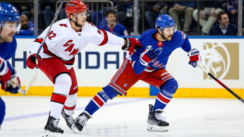 New York Rangers center Vincent Trocheck (16) and Carolina Hurricanes center Jesperi Kotkaniemi (82) chase the puck during the first period at Madison Square Garden