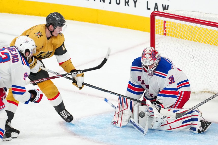 New York Rangers goaltender Igor Shesterkin (31) makes a save as Vegas Golden Knights left wing Pavel Dorofeyev (16) attempts a deflection during the third period at T-Mobile Arena