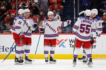 New York Rangers defenseman Adam Fox (23) celebrates with teammates after scoring a goal against the Washington Capitals in the second period at Capital One Arena