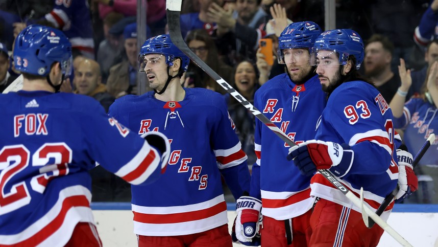 New York Rangers right wing Blake Wheeler (17) celebrates his empty net goal against the Seattle Kraken with defenseman Adam Fox (23) and left wing Chris Kreider (20) and center Mika Zibanejad (93) during the third period at Madison Square Garden