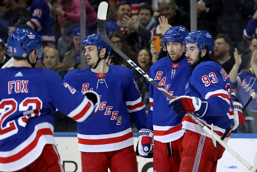 New York Rangers right wing Blake Wheeler (17) celebrates his empty net goal against the Seattle Kraken with defenseman Adam Fox (23) and left wing Chris Kreider (20) and center Mika Zibanejad (93) during the third period at Madison Square Garden
