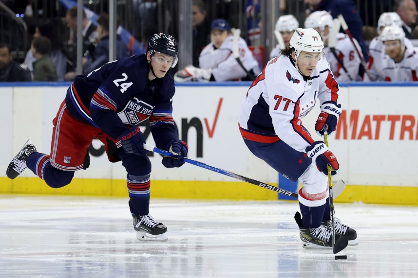 Washington Capitals right wing T.J. Oshie (77) brings the puck up ice against New York Rangers right wing Kaapo Kakko (24) during the third period at Madison Square Garden