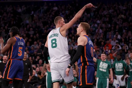 Boston Celtics center Kristaps Porzingis (8) celebrates his basket against New York Knicks guard Donte DiVincenzo (0) during the second quarter at Madison Square Garden